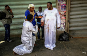 Prophet Samson Sangijnmi from Central Church of Christ is bleeding after he is being attacked by the mob who is going around searching for drugs in Pretoria, Church street.