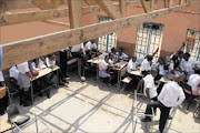 EXPOSED: Mmakaunyane High School pupils in North West sit in one of the classes of which the roofing was stolen by thieves during the December holidays. PHOTO: Peggy Nkomo. 13/01/2010. © Sowetan.