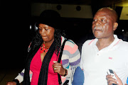 Senzo Meyiwa's father Samuel Meyiwa arrives with his sister Zanele Meyiwa at OR Tambo International Aiport on October 29, 2014 in Johannesburg, South Africa.