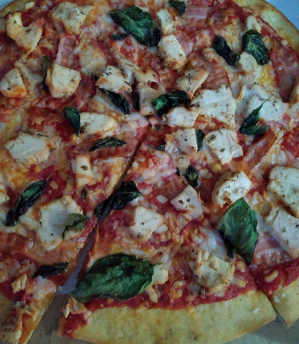 GF crust, unflavorful sauce, vegan cheese, basil, chicken and bacon.