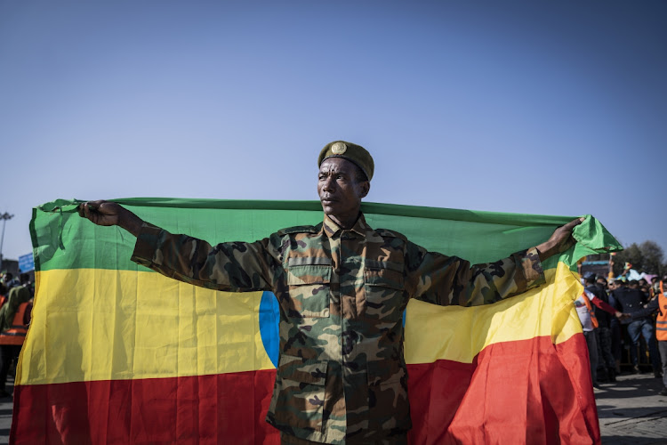 A war veteran carries the Ethiopian national flag in support of Ethiopian military troops who battling against the Tigray People's Liberation Front in the Amhara Region. Picture: Getty Images