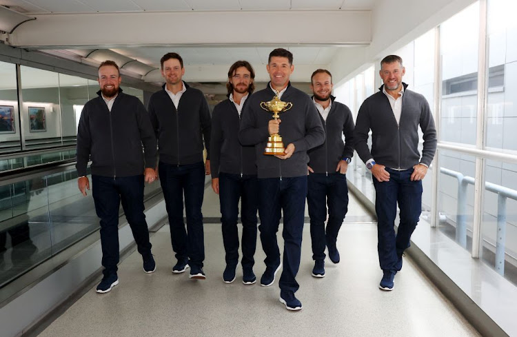 From left, Shane Lowry, Bernd Wiesberger, Tommy Fleetwood, captain Padraig Harrington, Tyrrell Hatton and Lee Westwood of Team Europe walk to the gate with the Ryder Cup trophy before departing Heathrow Airport ahead of the 43rd Ryder Cup on September 20 2021.