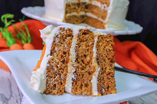 A slice of Addictive Carrot Cake on a plate.