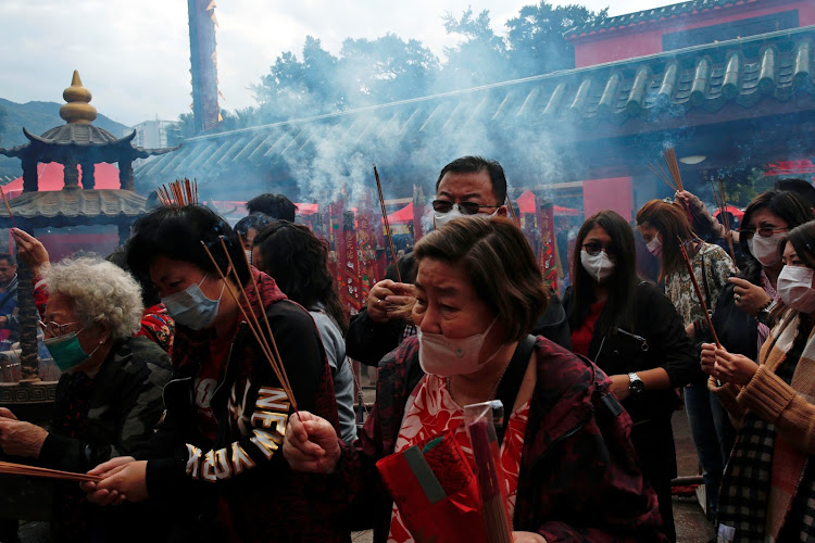 Worshippers wear masks to prevent an outbreak of a new coronavirus as they make offerings of incense sticks during a Lunar New Year celebration at Che Kung Temple, in Hong Kong, China January 26, 2020.