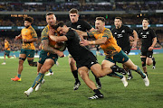 Anton Lienert-Brown of the All Blacks is tackled by Quade Cooper of the Wallabies in their Rugby Championship and Bledisloe Cup match at Melbourne Cricket Ground on July 29 2023. 