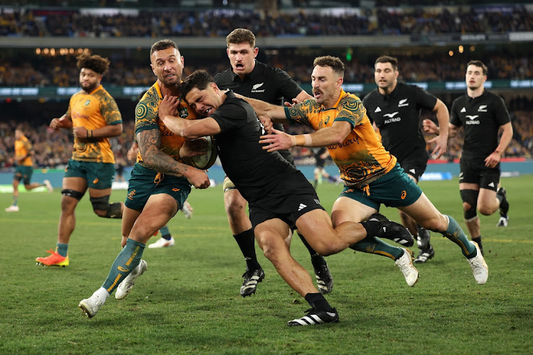 Anton Lienert-Brown of the All Blacks is tackled by Quade Cooper of the Wallabies in their Rugby Championship and Bledisloe Cup match at Melbourne Cricket Ground on July 29 2023.