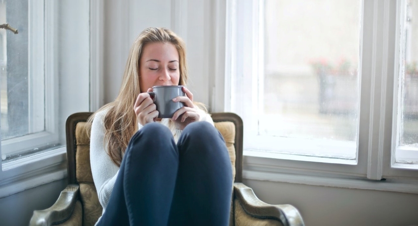 woman relaxing with a cup of tea in the middle of a move