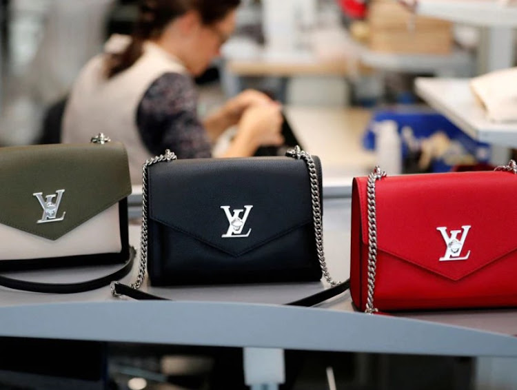 Louis Vuitton handbags are displayed as an employee works in a Vuitton new high-end garment factory in Beaulieu-sur-Layon, near Angers, France, September 5, 2019.