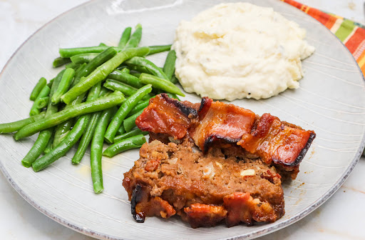 Slices of Apple Bacon Meatloaf on a plate.