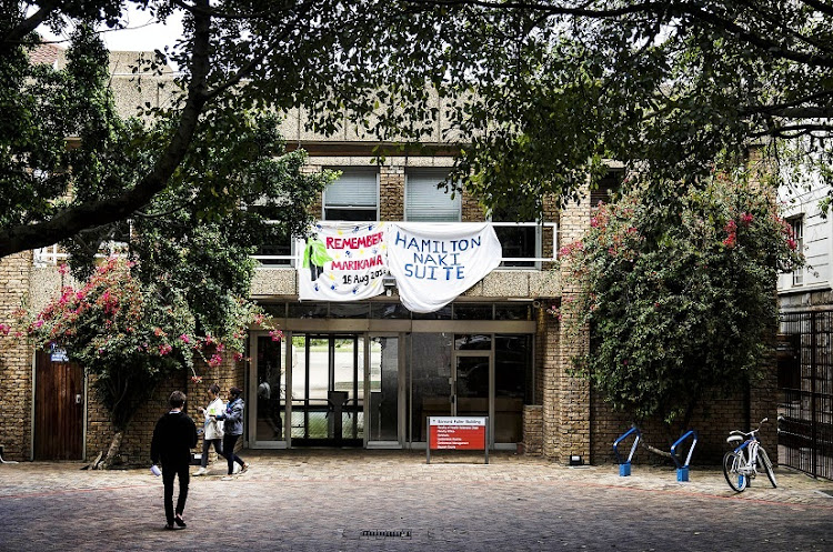 A banner on the health sciences building at the University of Cape Town in September 2016 renames the dean’s suite after Hamilton Naki, a black laboratory assistant to cardiac surgeon Chris Barnard. The banner was hung amid a FeesMustFall occupation of the dean’s office.