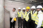 INSPECTION: Ellis Park Stadium architect Wynand Du Plessis, left, makes a point to Fifa's Alexander Klosterkemper, second from left, during the inspection of Ellis Park change rooms yesterday. Pic. Gavin Barker. 18/02/08. © Backpagepix.