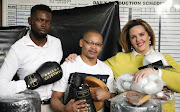 Trainer Silence Mabuza receives his equipment from Shereen Hunter and Bongani Dlamini of the Gauteng Boxing Promoters Association in Johannesburg.