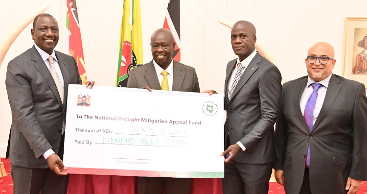 President William Ruto, Deputy President Rigathi Gachagua receiving donation cheque from Diamond Trust Bank which will go towards the National Drought Response on December 2, 2022.