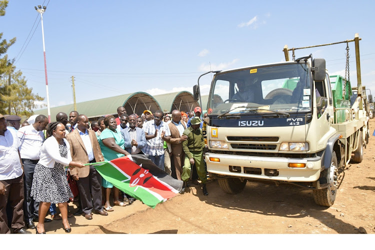 Kirinyaga governor Ann Waiguru flagging off trucks ferrying garbage skips to all major towns in the county.