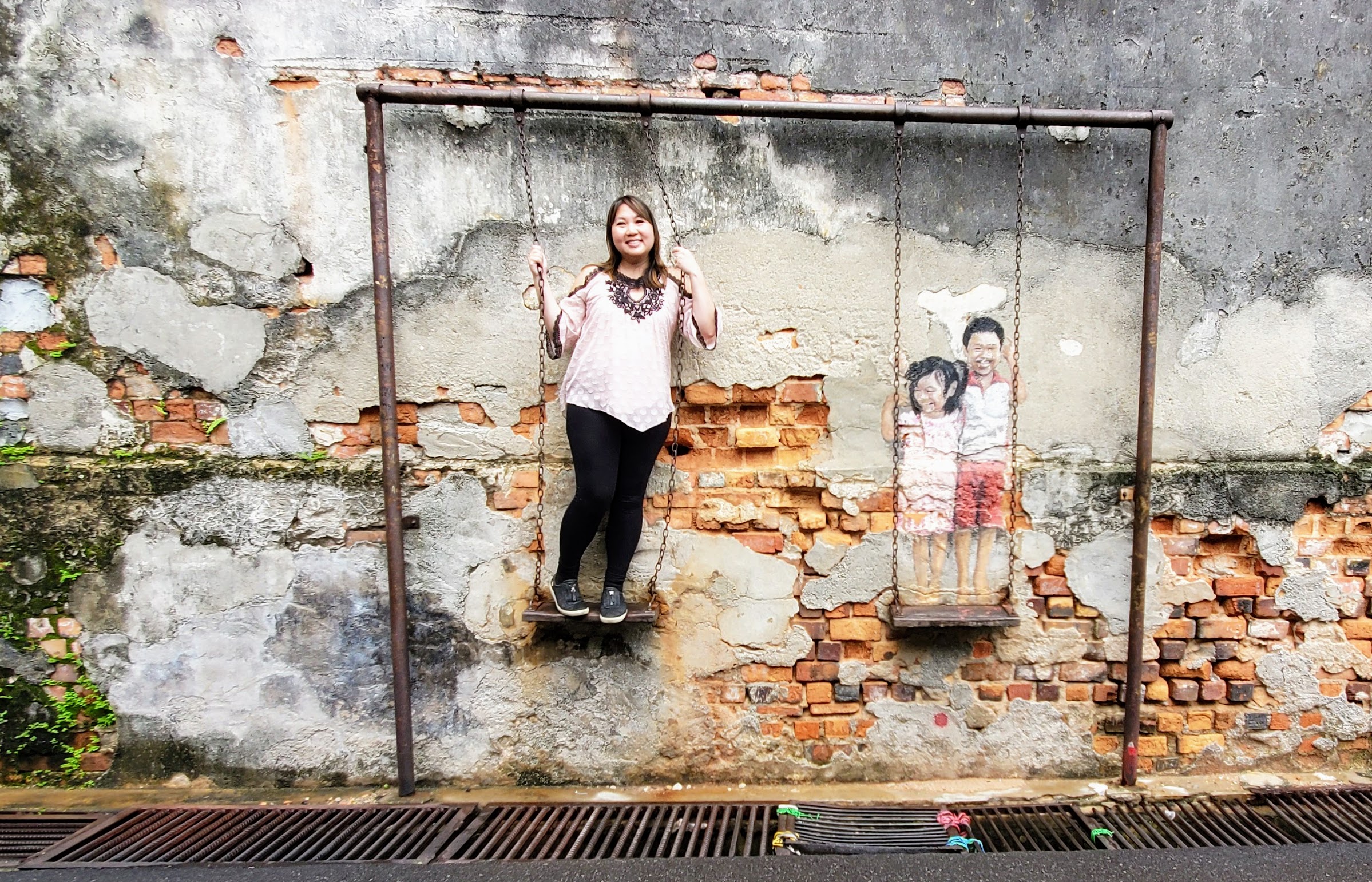 Tips on visiting George Town Street Art: a piece by Louis Gan, a local deaf-mute self-taught artist, called Brother and Sister on a Swing