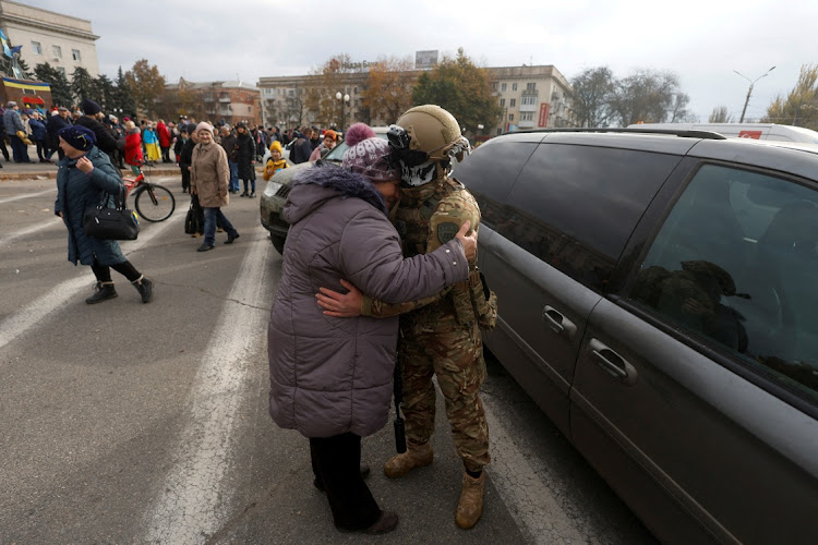 A woman embraces a Ukrainian service member in the city centre after Russia's retreat from Kherson, Ukraine November 16, 2022.