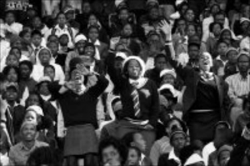 CELEBRATORY MOOD: Youngsters at the 32nd anniversary of the Soweto uprisings of June 16 held at Johannesburg Stadium. Pic. Veli Nhlapo.16/06/08. © Sowetan.