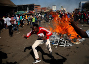 Supporters of the opposition Movement for Democratic Change party (MDC) of Nelson Chamisa react as they block a street in Harare, Zimbabwe, August 1, 2018. 