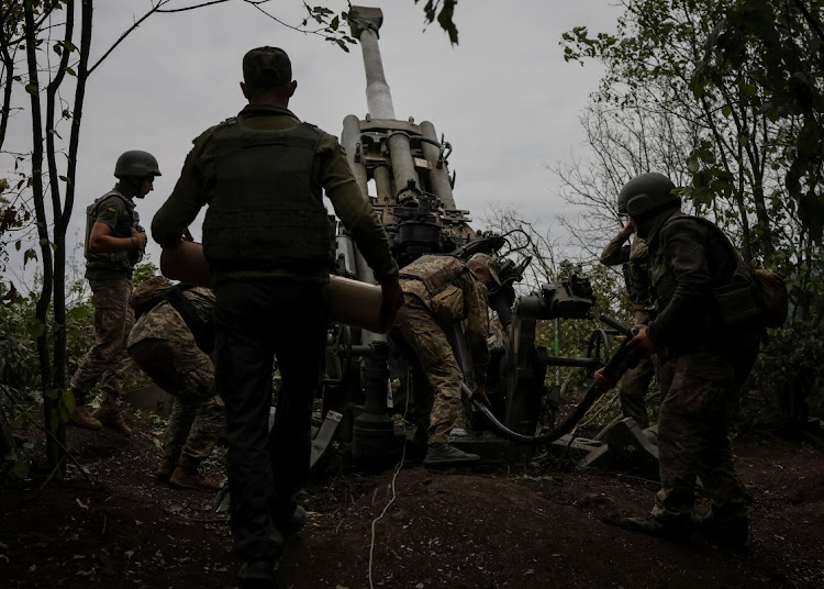 Ukrainian service members prepare to shoot from a M777 Howitzer at a front line, as Russia's attack on Ukraine continues, in Kharkiv Region, Ukraine, on July 21 2022.