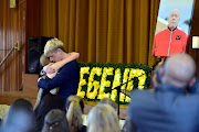 Mark Minnie Junior and his sister Brooklyn embrace during the memorial service for their father, Mark Minnie, in Port Elizabeth on August 24.