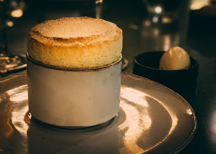 Usana banana bread soufflé with boeretroos sauce and cinnamon ice cream.