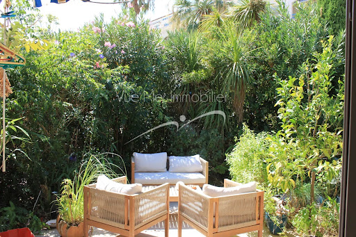 Outdoor lounge with sofa and armchairs in this luxury property for sale in Le Lavandou ($654,379 - 75 m²)