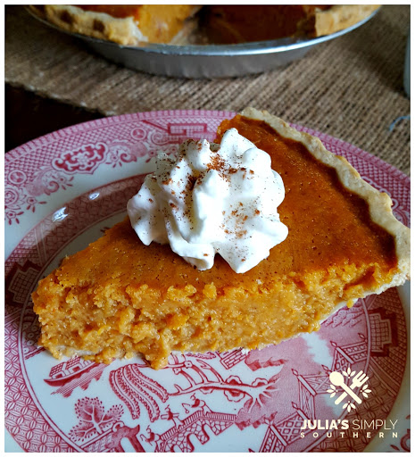 Slice of old fashioned sweet potato pie with whipped cream