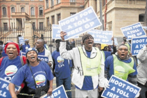 NO TO E-TOLLS: Democratic Alliance members and supporters chant outside the Pretoria High Court yesterday in support of an urgent court application that was filed against Gauteng's e-tolling system. PHOTO: VELI NHLAPO