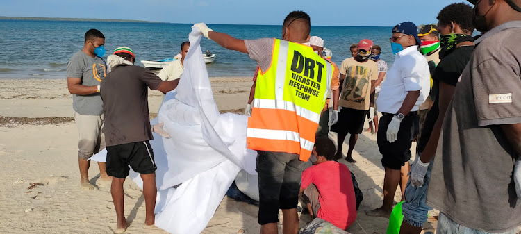 Burial rites are perfomed on the body of a drowning victim shortly after it was recovered from the Indian Ocean by divers in Lamu.