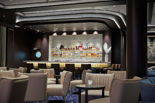 Relax with a cocktail at the main lounge aboard Seven Seas Splendor.