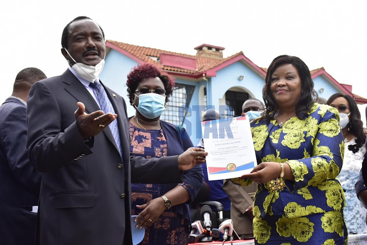 Wiper Democratic Party leader Kalonzo Musyoka presents the party nomination certificate to Machakos County Senator aspirant Agnes Kavisu Muthama during a press conference at Wiper Democratic party office in Karen on January 13, 2021.