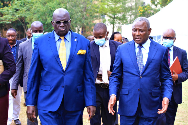 Education CS George Magoha walks alongside Equity Group CEO James Mwangi during the Nairobi annual conference for Wings to Fly and Elimu scholarships at Pangani Girls on Thursday April,14,2022