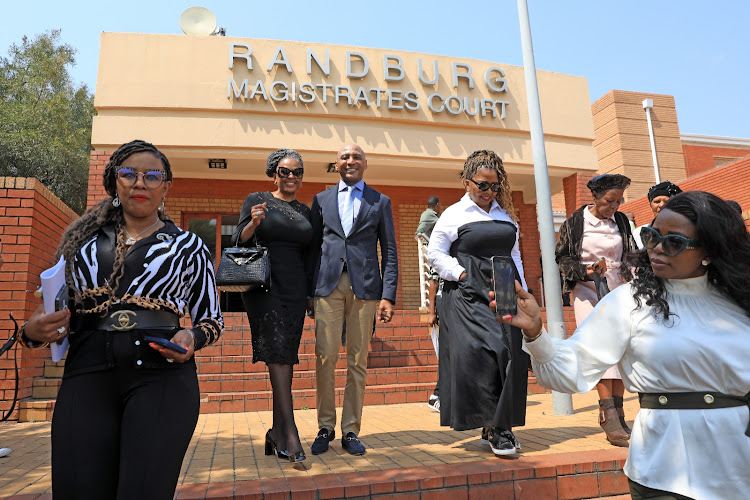 Power couple Romeo and Basetsana Kumalo pose with family after the judgment in the Randburg magistrate's court.