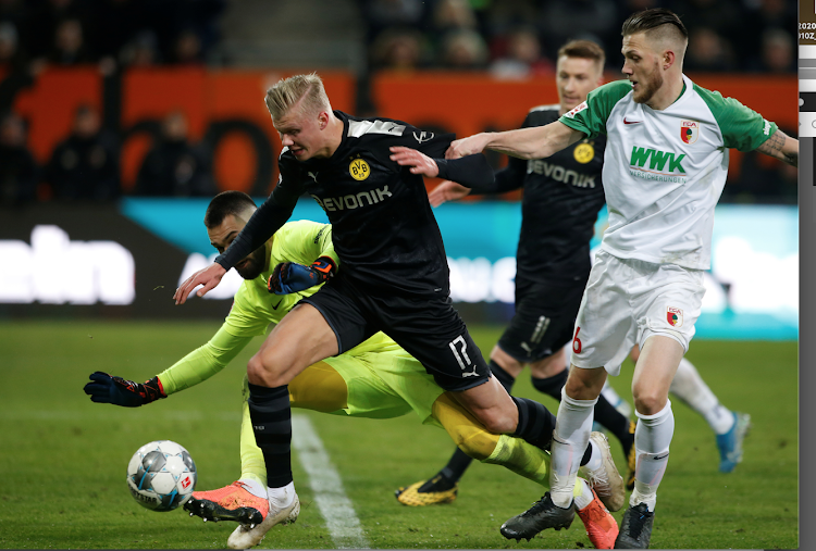 Borussia Dortmund's Erling Braut Haaland in action with FC Augsburg's Tomas Koubek