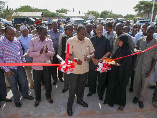 President Uhuru Kenyatta is guided on a tour when he officially opened the Garissa County Fire Department. Also present is Deputy President William Ruto, Garissa County Governor H.E. Nathif Adam Jamaa and Leader of Majority in the National Assembly Hon. Aden Dualle. PHOTO/PSCU