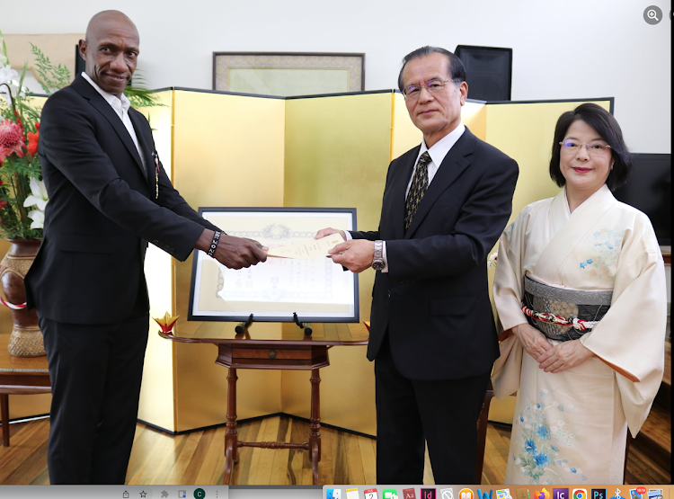 H.E. Horie Ryoichi, Ambassador of Japan to Kenya, presenting the Japanese decoration of “the Order of the Rising Sun, Gold and Silver Rays” to Douglas Wakiihuri