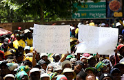 ANC members from greater Johannesburg region show their placards during a march to the offices of Mayor Herman Mashaba and Eskom to handover memorandums demanding better service delivery on October 5 2018

