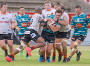 Andre Swarts of Griquas tackled by Andisa Ntsila and Jeandré Rudolph of Cheetahs during the Carling Currie Cup match between Tafel Lager Griquas and Toyota Cheetahs at Tafel Lager Park on January 09, 2021 in Kimberley, South Africa.