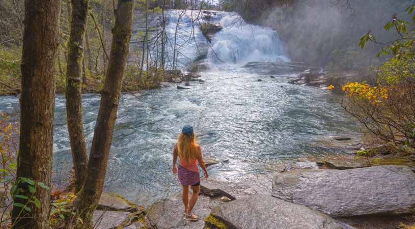 A woman looking out at the High Falls of Dupont State Forest