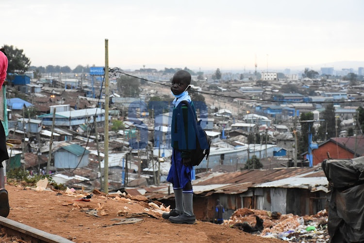 A pupil walk to school in Kibera Slums