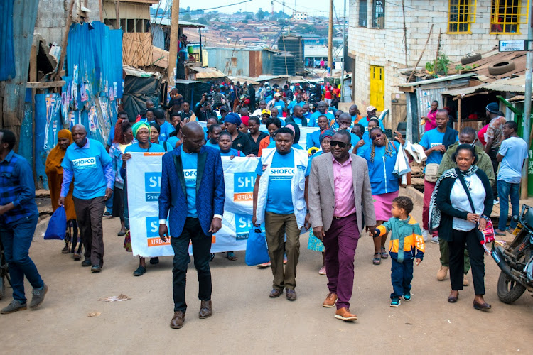 Community leaders from 13 slums in Nairobi pledged to preach ahead of the general election in Kibera on Friday, July 29, 2022.. They were led by Shofco CEO Kennedy Odede (in pink shirt)