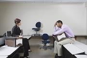 Depressed man sitting on desk. 