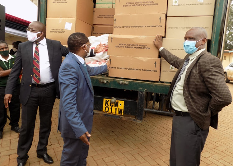 Equity Bank's Chief Commercial Officer Polycarp Igathe Embu Governor Martin Wambora and Embu County Commissioner Abdullahi Galgalo during donation of PPEs to Embu by Equity Bank