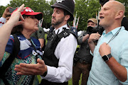 Supporters of US president Donald Trump argue with police officers outside Buckingham Palace during his state visit to Britain. 