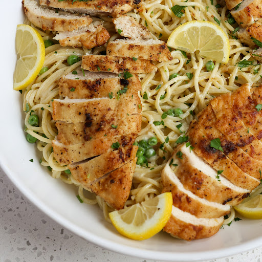 Lemon Chicken Pasta is loaded with lightly breaded lemon pepper seasoned chicken breasts, creamy lemon sauce with Parmesan cheese, and sweet peas.