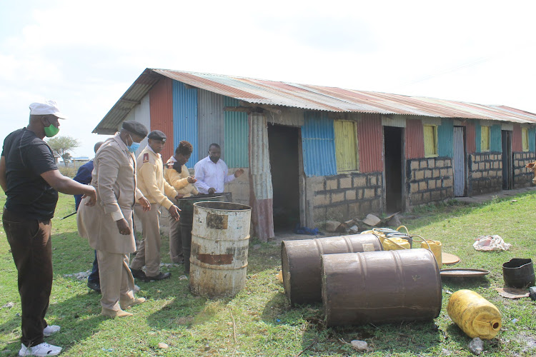 Athi River local provincial administrators conficsicate chang'aa at a den in County estate, Machakos County on February 12.