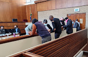 Knowledge Mhlanga (centre) and the other accused consult with their lawyers in the murder and kidnapping trial surrounding the 2018 case of Gabisile Shabane and her nephew, Nkosikhona  Ngwenya.