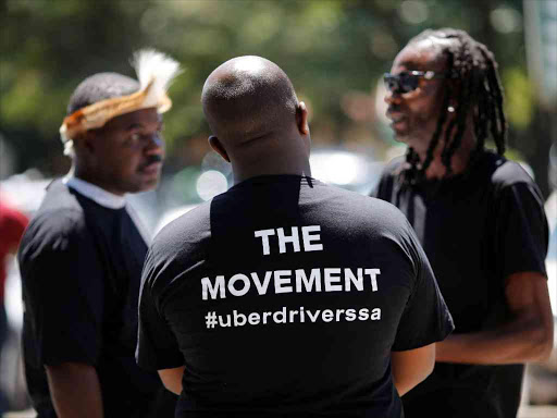 Uber drivers gather outside the company's offices in Parktown, a suburb of Johannesburg, South Africa, March 10, 2017. /REUTERS