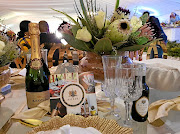 Glass tables in a glass-enclosed marquee at the KwaLinduzulu Palace were decorated with Proteas, crystal glasses, white-and-gold cutlery and bottles of King Goodwill Zwelithini's special sparkling wine.