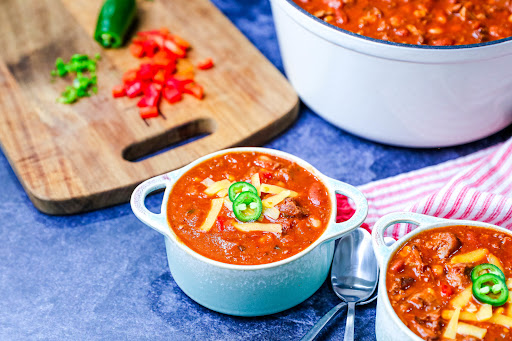 Bowl of Three Amigos Chili with shredded cheese.